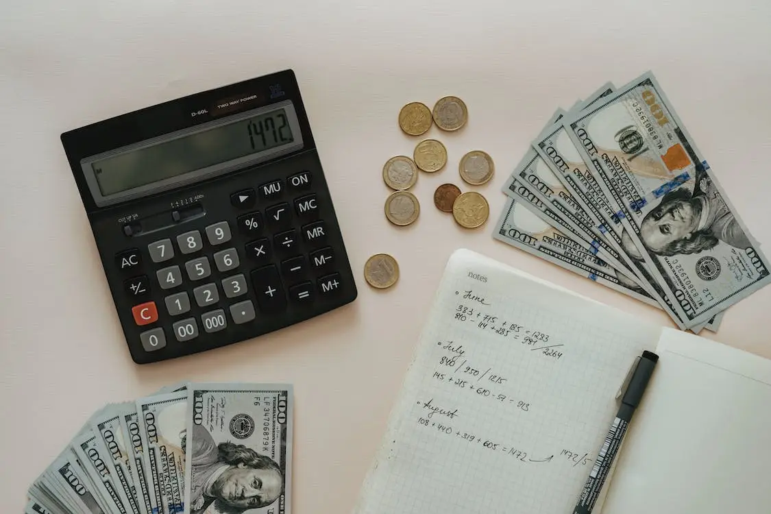 a calculator and coins on a paper