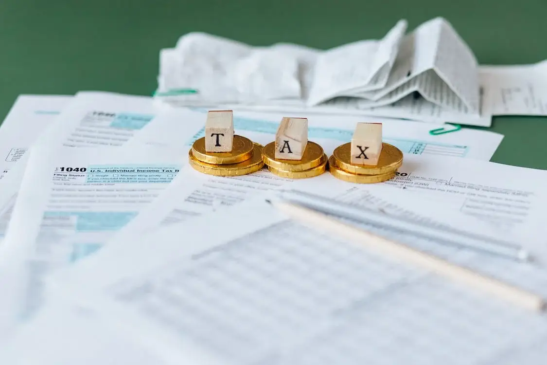 a calculator and coins on a paper